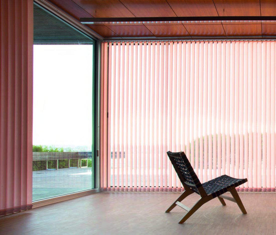 Vertical blind system in a rose-toned living room